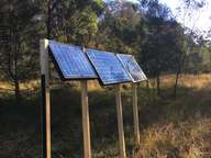 a solar panel in a field of grass